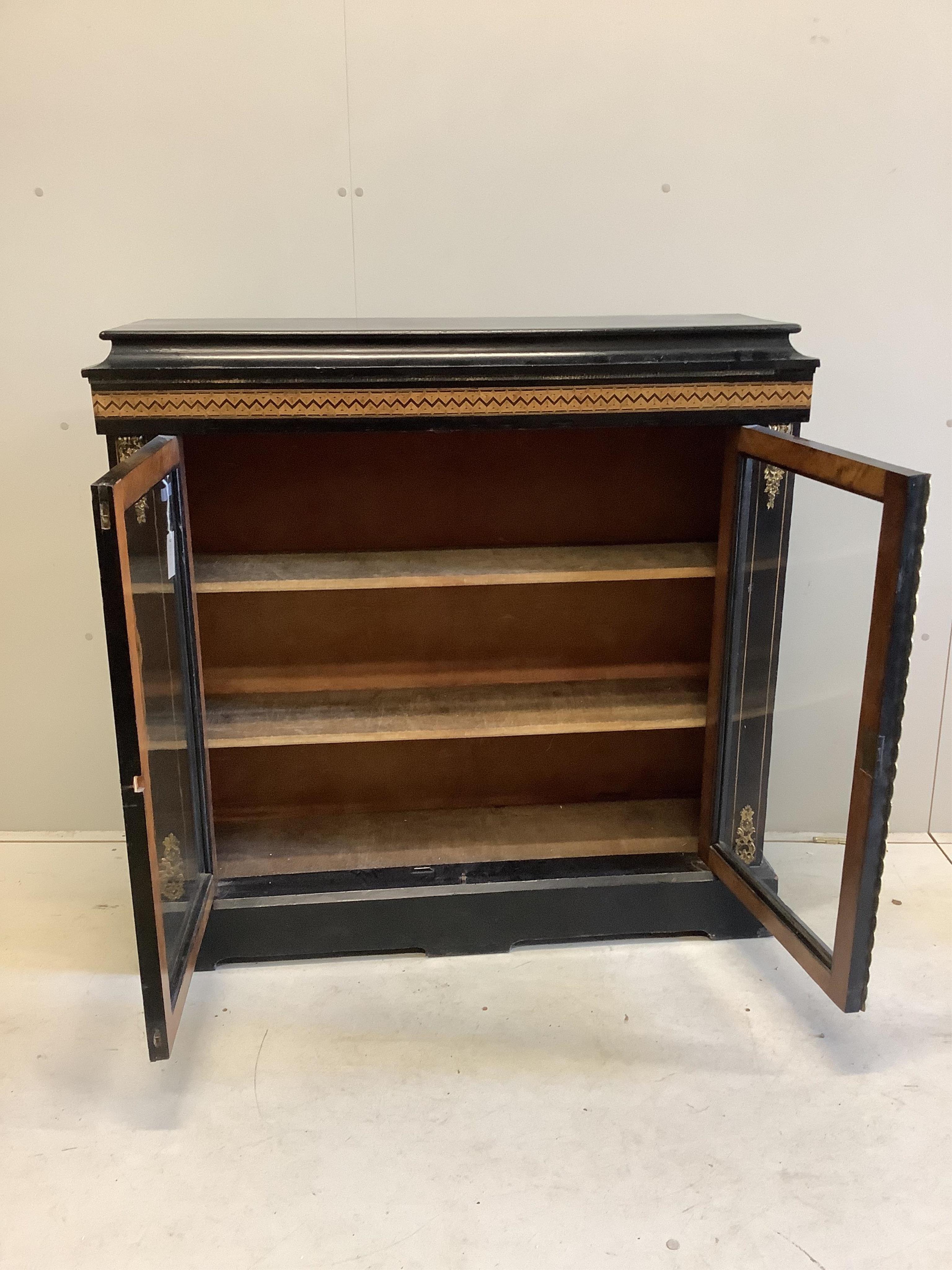 A late Victorian parquetry inlaid gilt metal mounted ebonised pier cabinet, width 113cm, depth 34cm, height 110cm. Condition - fair